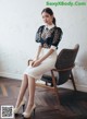 A woman sitting on a chair in a room.