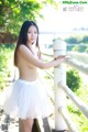 A young woman in a white tutu posing for the camera.