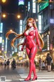 A woman in a red latex outfit standing in the middle of a city street.