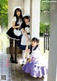 A group of three young women dressed in maid outfits.